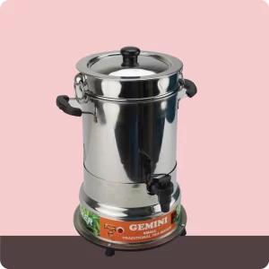 A stainless steel traditional tea maker with black handles and a spout, labeled Gemini Small Traditional Tea Maker, placed on a pink and brown background .