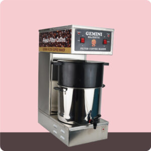 A stainless steel Gemini majestic filter coffee maker with control buttons, a coffee pot, and a spout, set against a pink background.